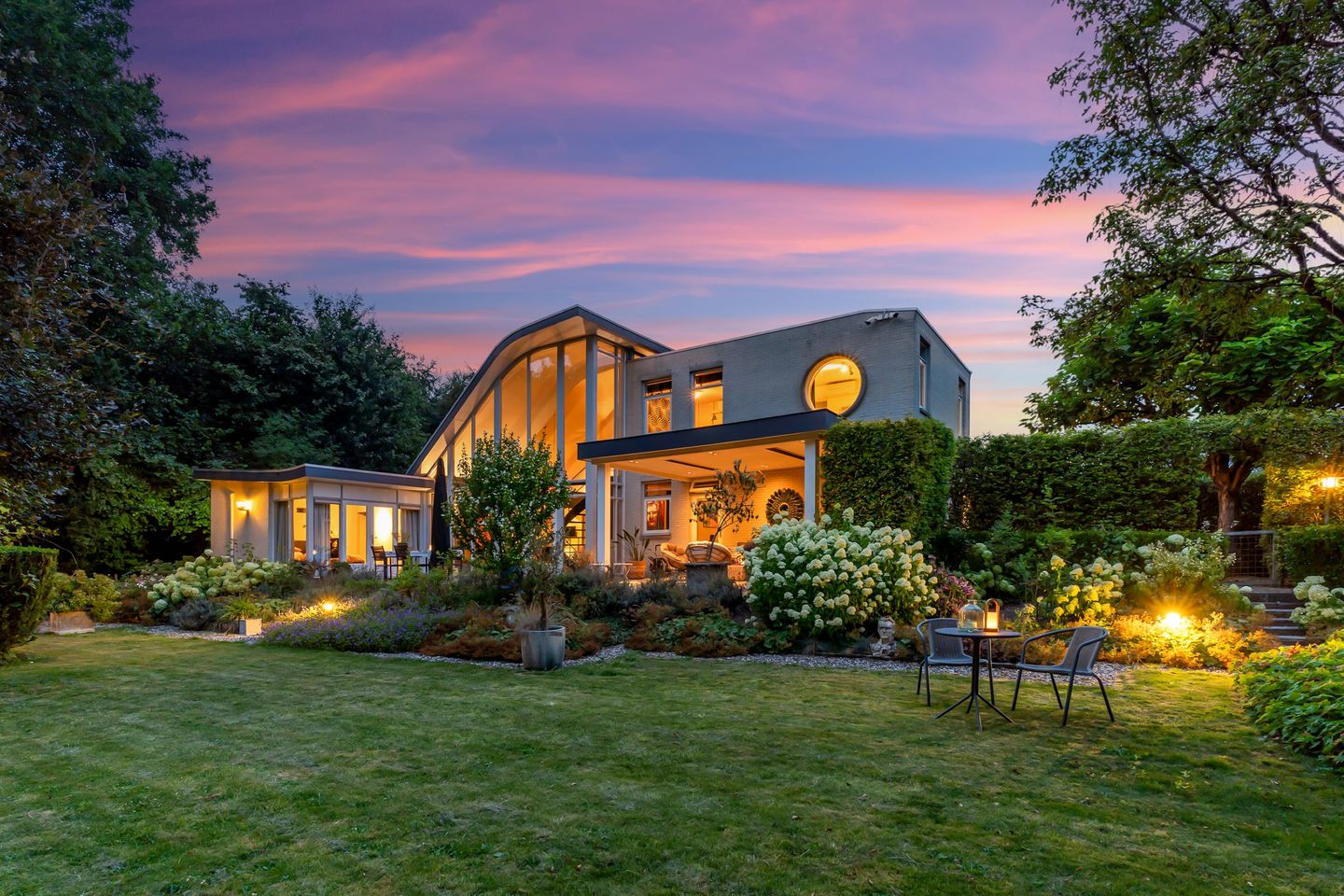 De villa in de avondschemering, gezien vanuit de tuin